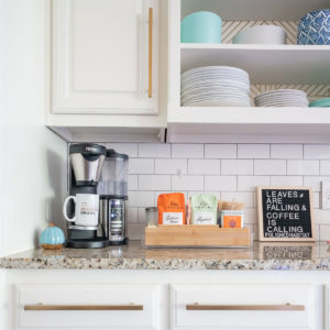 Cofffee station on kitchen counter - white cabinets with gold pulls